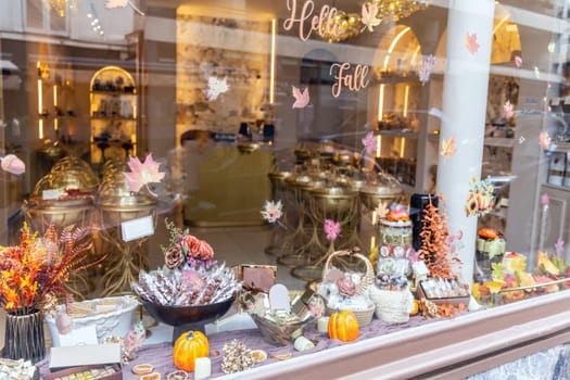 A pasrty shop window decorated with autumn leaves. High quality photo