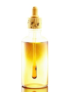 Frosted glass face oil bottle with a bamboo dropper lid, filled with a rich, amber-colored liquid, set against a plain