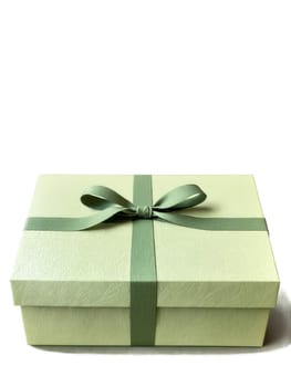 Elegant gift box in soft sage, with a subtle textured pattern and a minimalist ribbon closure.