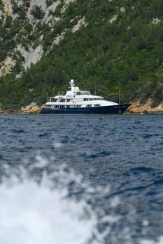 Scenic view of Magnificent luxury yacht and Cap Canaille headland and Cassis in south of France, High quality photo