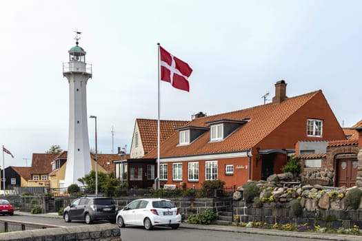 Lighthouse with the Danish flag in a small town Ronne, Bornholm, Denmark - November 25, 2024.