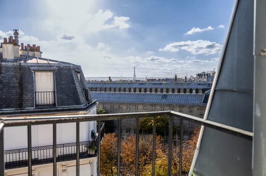 View from the open window of the city of Paris rooftops and Eiffel Tower. Paris, France. High quality photo