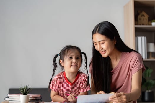 A joyful parent and child bonding over educational activities, surrounded by books in a cozy home setting.