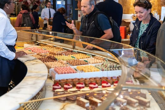 Various assortment of desserts confectionery on the counter in a bakery. Paris, France - November 15, 2024