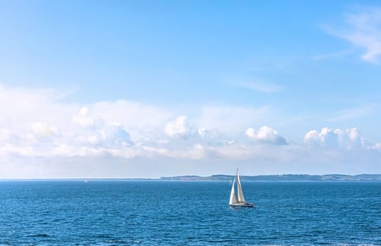 Sailboat at sea on a sunny day. Beautiful seascape.
