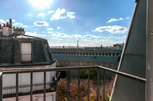 View from the open window of the city of Paris rooftops and Eiffel Tower. Paris, France. High quality photo