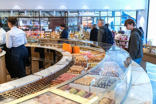Various assortment of desserts confectionery on the counter in a bakery. Paris, France - November 15, 2024