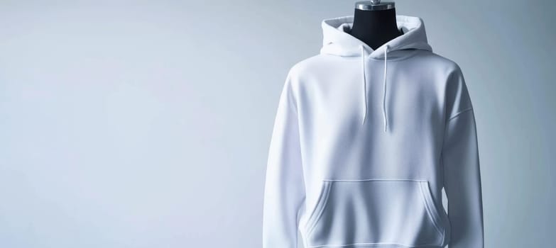 Plain white hoodie showcased on a mannequin, its texture and design against a neutral background. perfect for online clothing stores and fashion designers to emphasize simplicity and quality of fabric details.