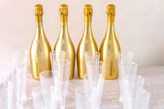 Bottega Champagne bottles and plastic champagne glasses. Celebrating an event. Copenhagen, Denmark - August 20, 2023