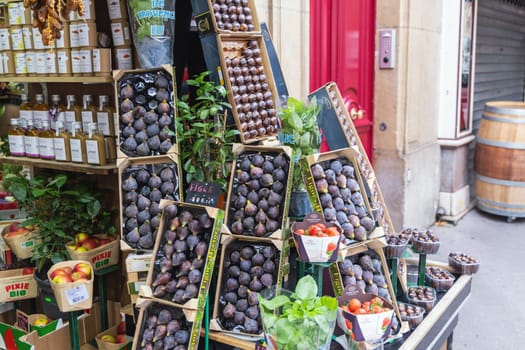 Shop with various fruits and figs outside. French fruit market. Paris, France - November 11, 2024