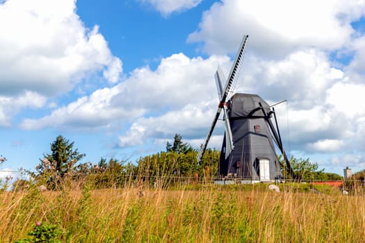 Windmill on a field and blue sky with clouds. Rural landscape. High quality photo