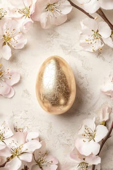 Elegant easter greeting card design featuring a central gold foiled egg surrounded by delicate floral patterns in muted pastels. the sophisticated layout offers a blank space for a personalized message, perfect for springtime celebrations.