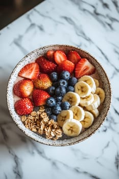 Vibrant smoothie bowl filled with strawberries, blueberries, and bananas, topped with chia seeds and granola. set on a marble surface, emphasizing freshness and a healthy lifestyle. perfect for wellness, food blogs, and healthy eating inspiration.