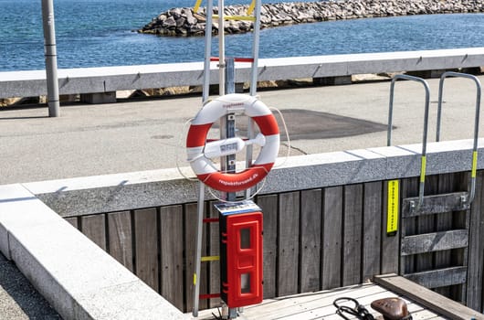 Lifebuoy hang on the pier. Concept of a safe holiday. High quality photo