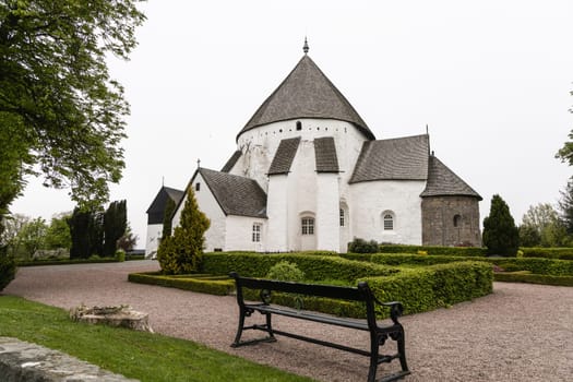White round Osterlars church on the island of Bornholm. Concept of historical building and landmarks of Denmark.