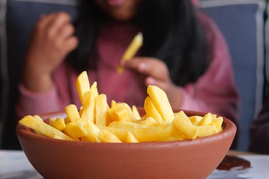 child eating french fries close up ,