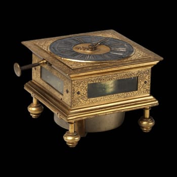 An antique gilded table clock by Johann Kleinschmidt, circa 17th century. The clock features a lavishly gilded brass frame with intricate details.