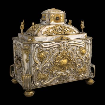 Antique silver strongbox with clockwork and ornate embossed details.