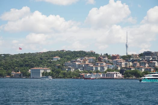 The breathtaking waterfront view of Istanbul features stunning hills along with a majestic tower
