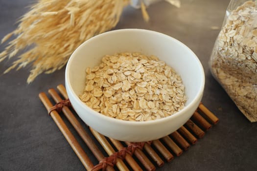 A nourishing bowl of oats complemented with fresh wheat stalks, perfect for healthy meals