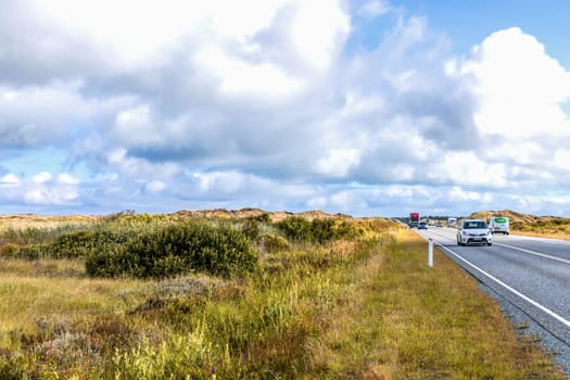 Highway with cars on a cloudy day. Denmark - Oktober 11, 2023
