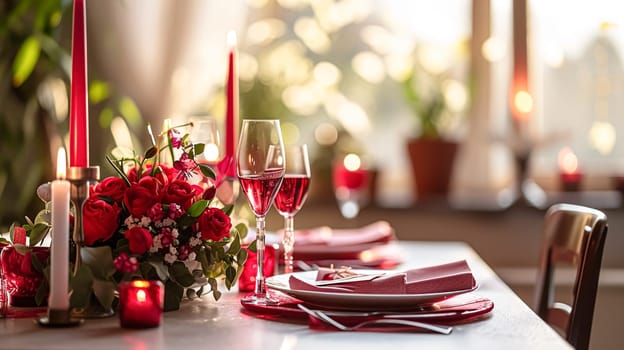 Festive table setting with candles and arrangement of beautiful red flowers. Holiday concept. High quality photo