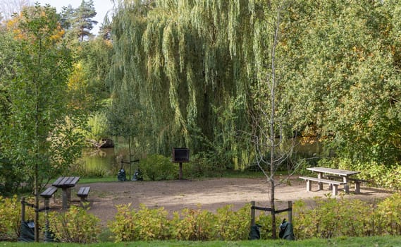 Barbecue area in the park with a grill and wooden tables. High quality photo