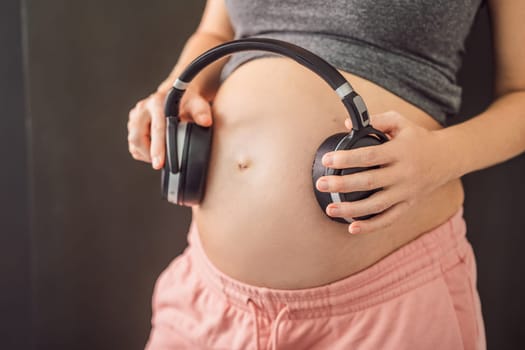 Melodies in the womb: Headphones placed on a pregnant belly, bonding through music, a heartwarming connection between mother and baby.