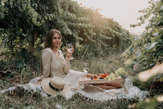 Picnic and wine tasting at sunset in the hills of Italy, Tuscany. Vineyards and open nature in the summer. Romantic dinner, fruit and wine.