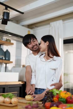 Couple cutting potatoes to cook or make salad in home kitchen