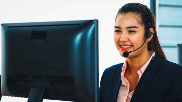 Business people wearing headset working in office to support remote customer or colleague. Call center, telemarketing, customer support agent provide service on telephone video conference call. Jivy