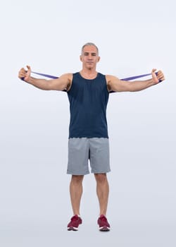 Full body length shot athletic and sporty senior man with fitness resistance band on isolated background. Healthy active physique and body care lifestyle after retirement. Clout