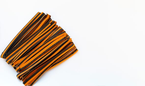 Black And Orange Pappardelle Italian Pasta, Fresh Wheat Product on White Background. Top View, Space For Text. Egg Dry Ribbon Noodles, Long Rolled Macaroni or Uncooked Spaghetti Isolated. Horizontal.