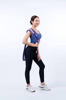 Vigorous energetic woman in sportswear portrait stretching resistance sport band. Young athletic asian woman strength and endurance training session workout routine concept on isolated background.