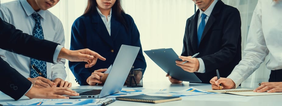 Business people in group meeting in formal attire share idea discussing report for company profit in creative workspace for start up business shot in close up view on group meeting table . Oratory .