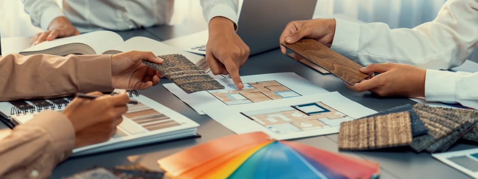 Group of interior designer team in meeting, discussing with engineer on interior design and planning for house project blueprint and model, choosing various mood board materials. Insight