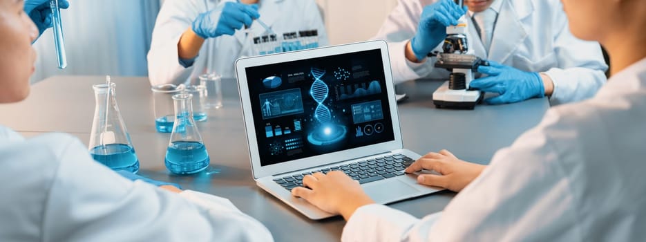 Dedicated scientist group working on advance biotechnology computer software to study or analyze DNA data after making scientific breakthrough from chemical experiment on medical laboratory. Neoteric