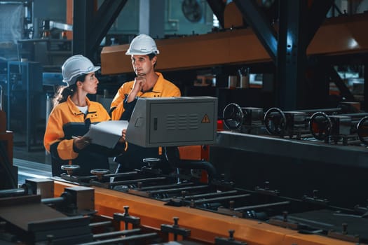 Professional quality control inspector conduct safety inspection on steel machinery and manufacturing process. Factory engineer or operator make optimization in heavy industry facility. Exemplifying