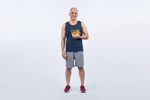 Happy smile senior man portrait holding bowl of vegan fruit and vegetable on isolated background. Healthy senior people with healthy vegetarian nutrition and body care lifestyle. Clout