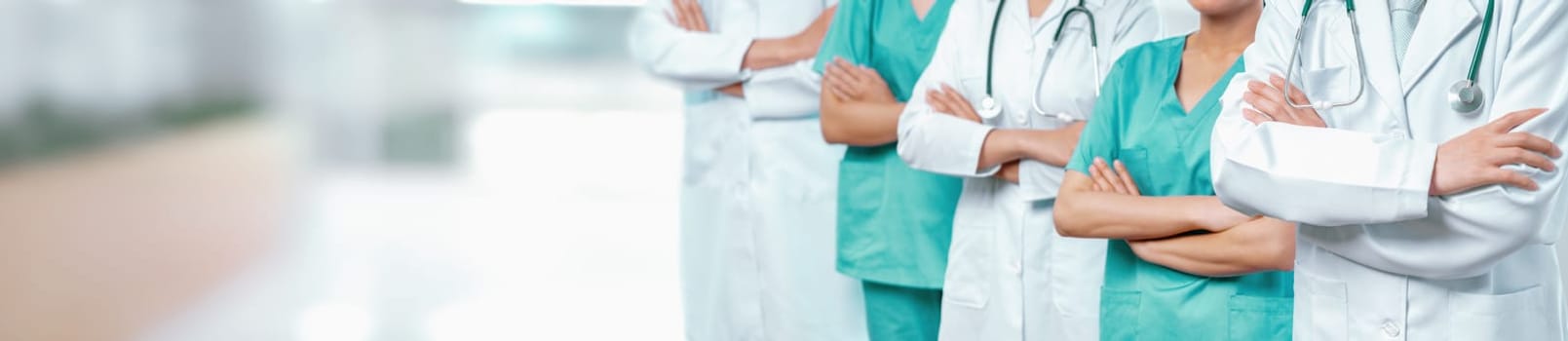 Confident medical staff team with doctor nurse and healthcare specialist professions people in blurry hospital corridor background. Medical and healthcare community in panoramic banner. Neoteric