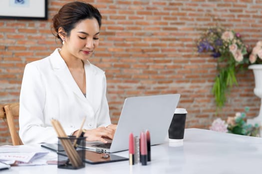 Online seller business woman working at remote office. The businesswoman check sale profit in laptop computer. uttermost