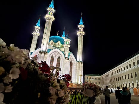 Kul Sharif Mosque stands proudly at night in Kazan, with its vibrant blue domes and towering minarets illuminated against the dark sky.