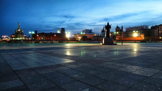 Yoshkar-Ola, Russia - April, 2023: Nighttime reveals the serene beauty of Yoshkar-Ola's Bruges embankment and the striking monument illuminated against the sky.