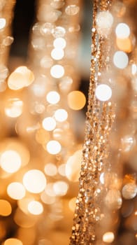 Golden sequins hanging and shimmering, creating a festive and glamorous atmosphere with defocused lights in the background