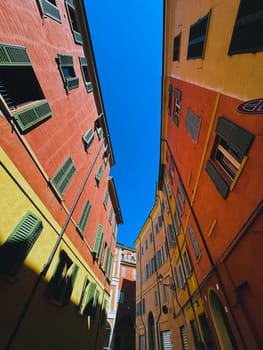 A vibrant and lively view of the colorful buildings lining a narrow alleyway on a bright sunny day in town