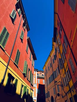 A sunlit alley beautifully showcasing vibrant and colorful architecture within a picturesque urban setting