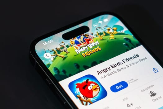 New York, USA - December 20, 2024: Angry Birds Friends game app displayed on smartphone screen with logo. Multiplayer puzzle game featuring bird characters and competitive gameplay