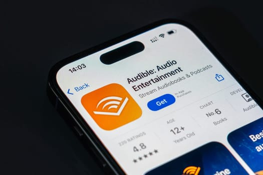 New York, USA - December 20, 2024: Audible app displayed on smartphone screen with logo. Audio entertainment application offering audiobooks, podcasts, and exclusive content
