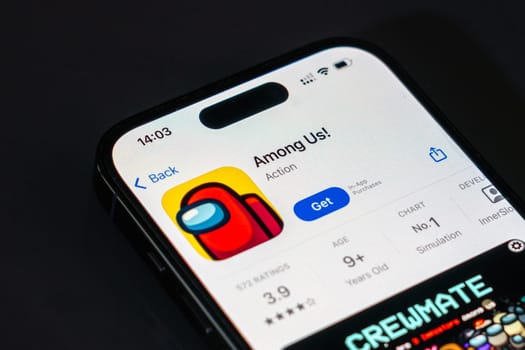 New York, USA - December 20, 2024: Among Us game app displayed on smartphone screen with logo. Popular multiplayer game focused on teamwork and deception