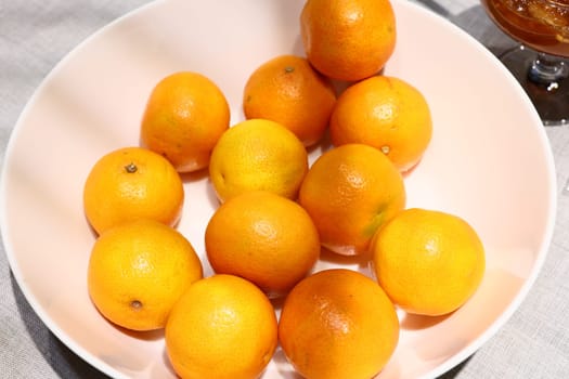 A vibrant arrangement of fresh oranges placed beautifully in a bowl, perfect for healthy snacking and decoration